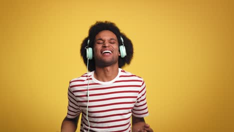 young man having fun during listening music and dancing