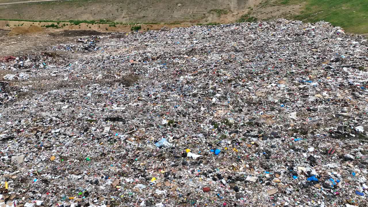 Aerial Drone Flyover of landfill with filled trash