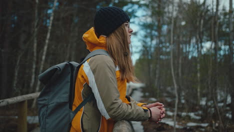 female hiker enjoys forest view then walks away, slow motion