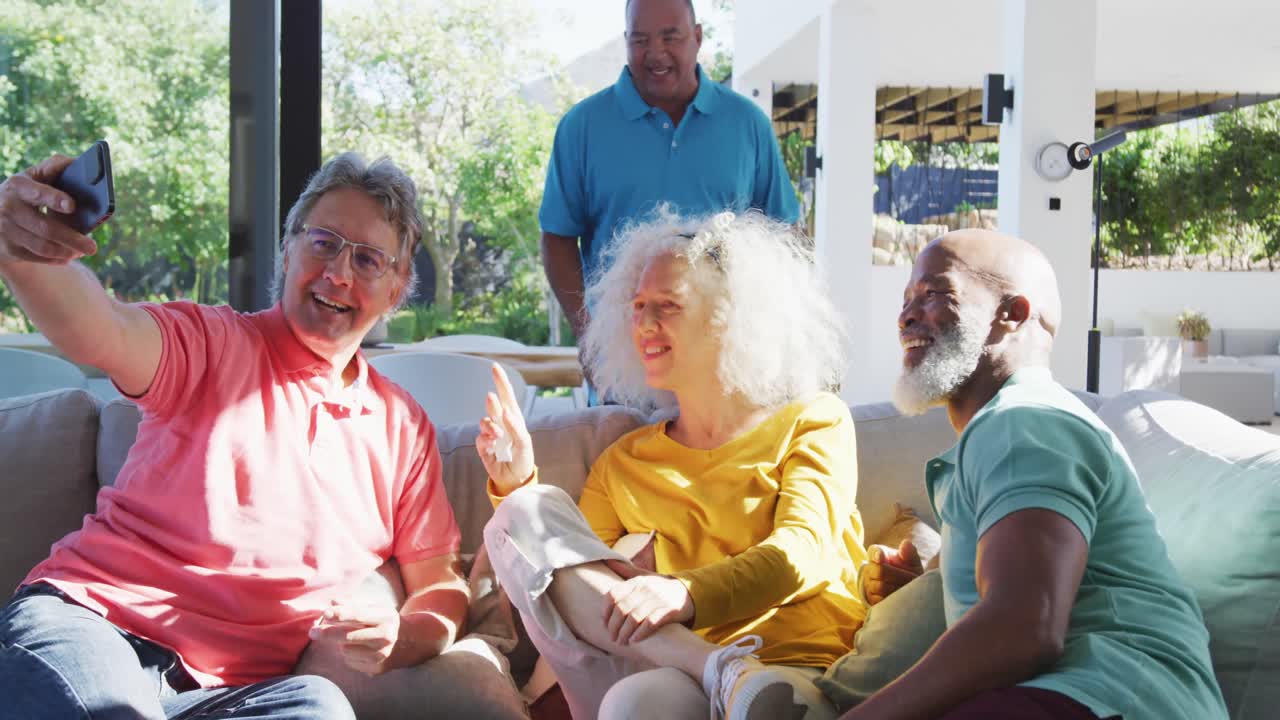 Happy senior diverse people taking selfie at retirement home