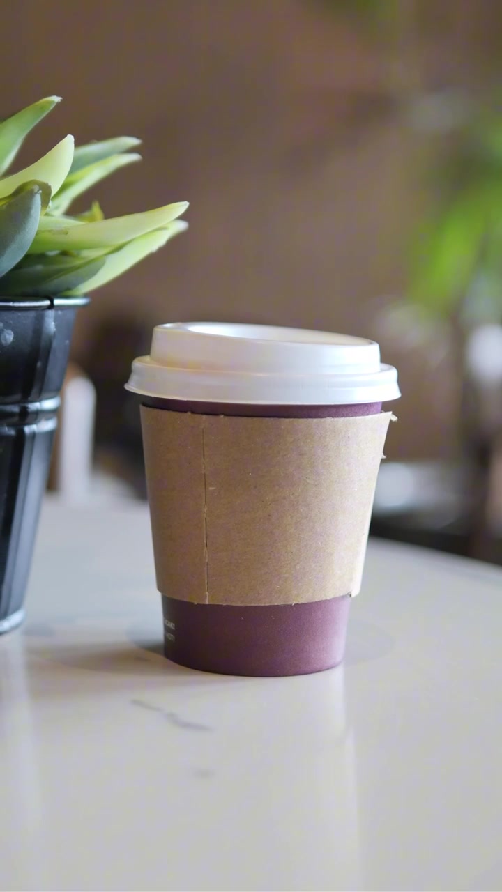 Bicchiere di caffè da asporto su un tavolo in un bar