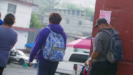 Slow motion dramatic shot of street view of people walking among street vendors in Zone 18 Guatemala City Guatemala - handheld