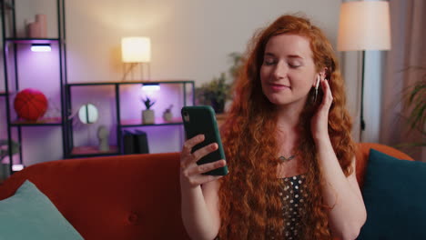 Red-hair-woman-enjoying-smartphone-call-talking,-mobile-phone-conversation-with-friends-at-home