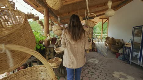 woman buying wicker basket in a household goods store