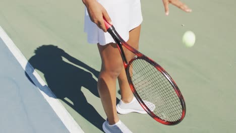 Video-of-midsection-of-african-american-female-tennis-player-holding-racket