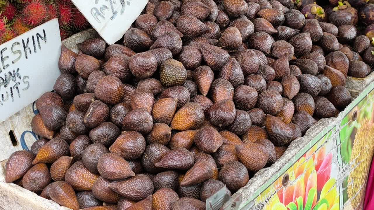 A pile of Salak fruit is displayed for sale. This sweet and somewhat rare tropical fruit, also known as snake fruit, is ready to be purchased