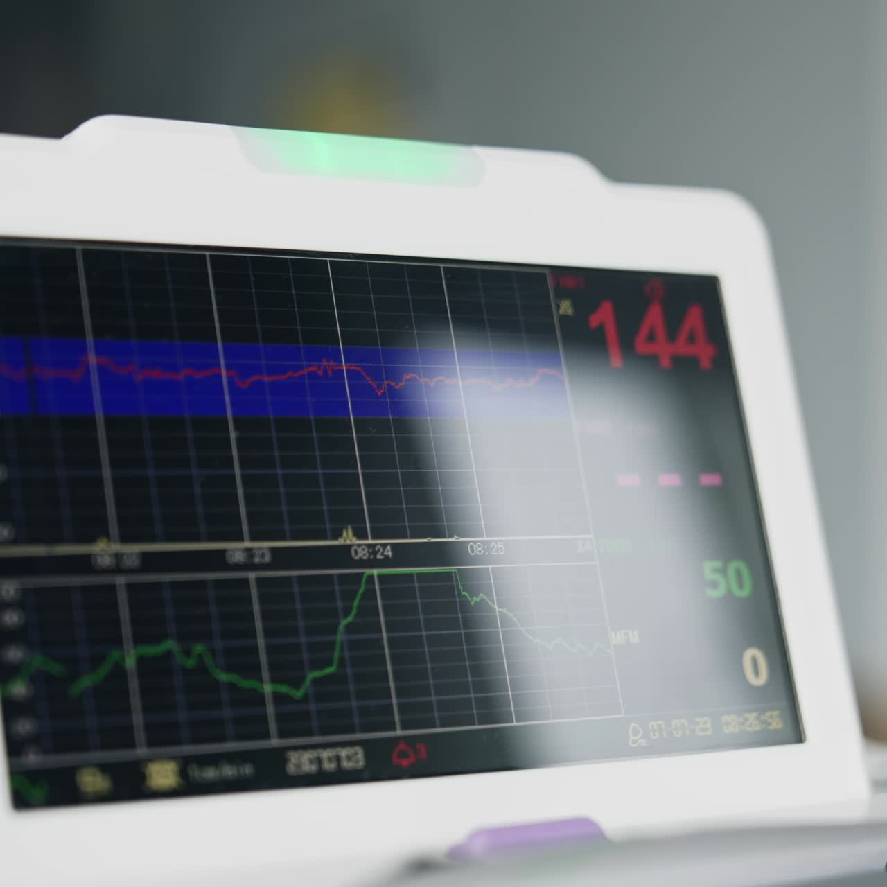 Little dark screen with curved lines close up. Medical equipment monitoring fetal development