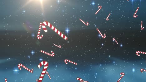 Multiple-candy-cane-icons-falling-against-blue-shining-stars-on-blue-background