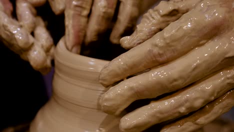 potter is making clay pot on the potter's wheel