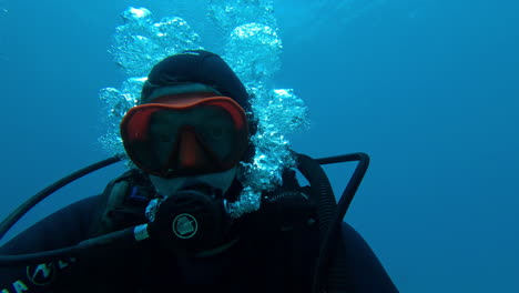 Embark-on-an-underwater-adventure-with-a-scuba-diver's-captivating-selfie-as-he-explores-the-depths-of-the-mesmerizing-blue-abyss