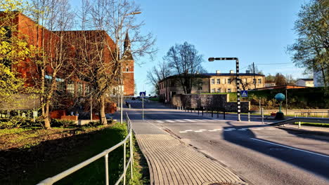 empty street with view on st. simon’s church and renovated theater in valmiera, latvia