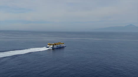 side-tracking aerial shot of the fred olsen company ship whose destination is the island of tenerife