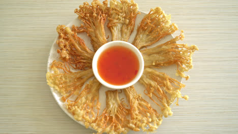 deep fried enoki mushroom or golden needle mushroom with spicy dipping sauce - vegan food style