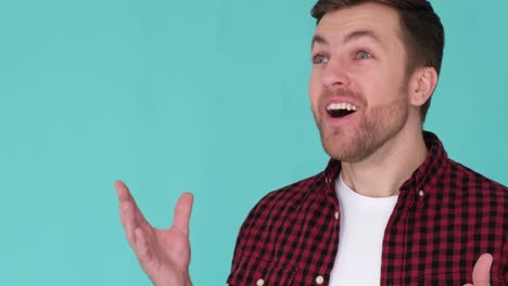 excited amazed young guy happy success victory gesturing with hands looking at camera. excited amazed young guy happy success, victory, gesturing with hands, looking at camera, smiling, isolated blue . video