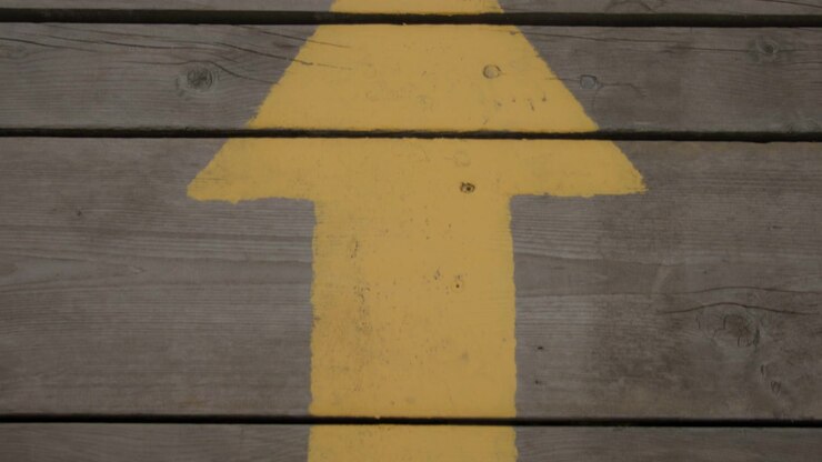 Walking down the wooden boardwalk with painted direction signage