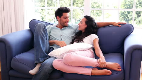 attractive couple chatting on the couch