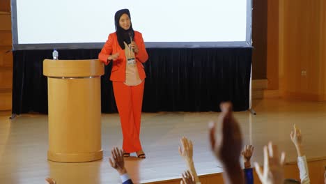 woman speaking in speaker at podium in auditorium 4k