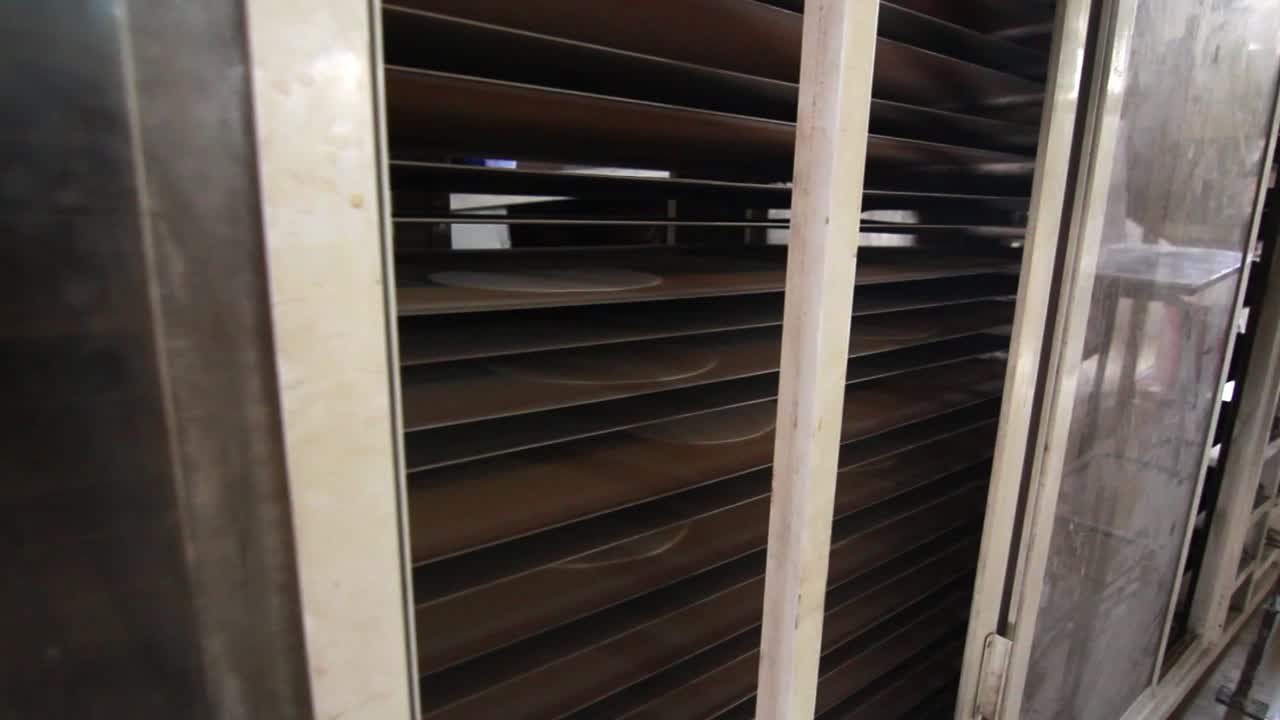 Interior shot of local bakery moving belt with bread on top