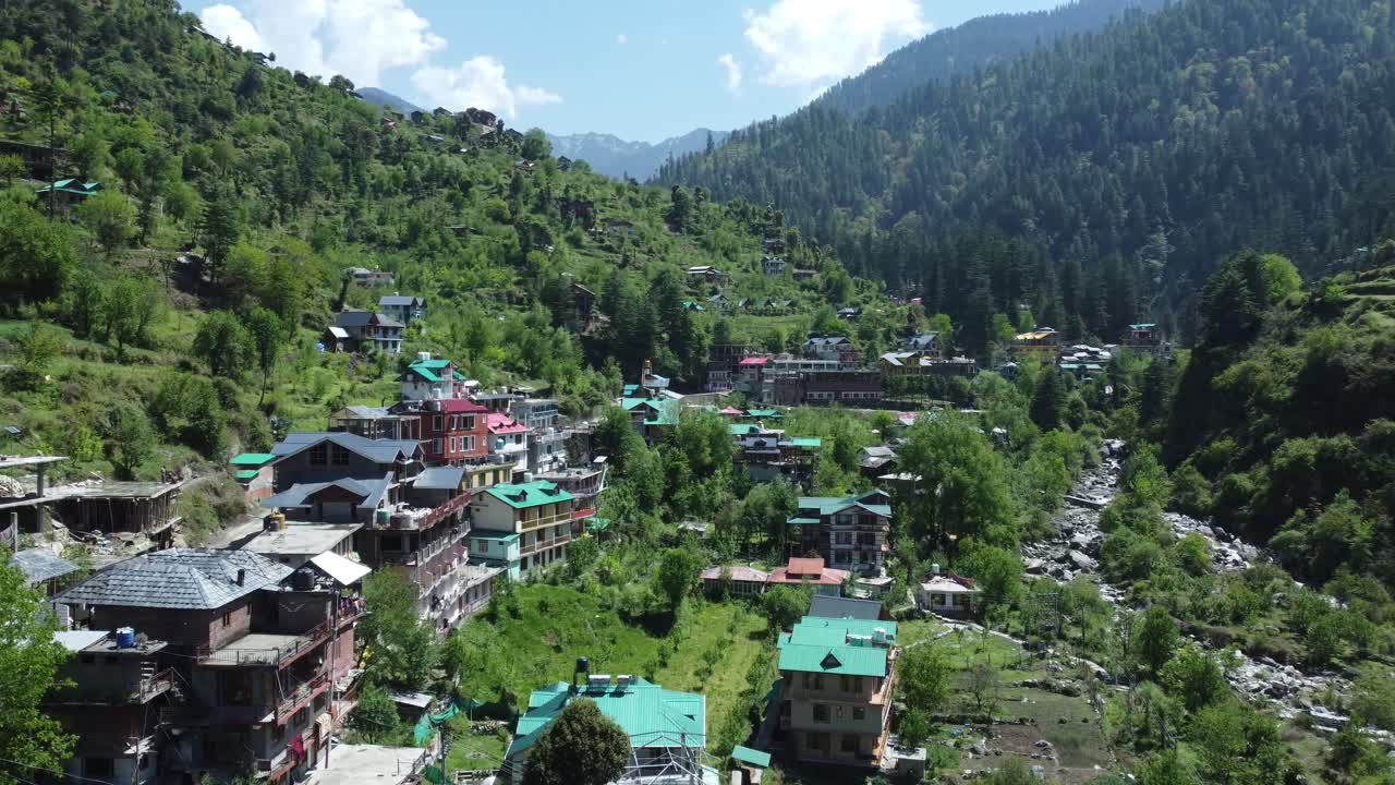 Aerial view short of Jibhi Himachal Pradesh in India. Houses and trees in the mountainous area. Faguli festival is one of the biggest festival in Jibhi. The traditional houses here have stone roofs.