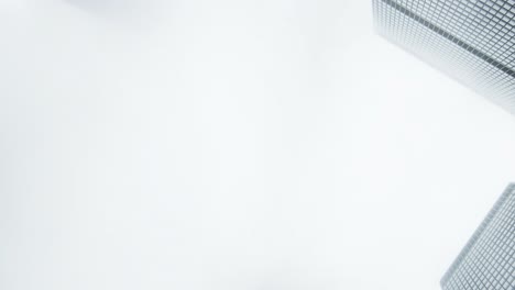 zooming up while rotating capturing buildings on a cloudy day with fog