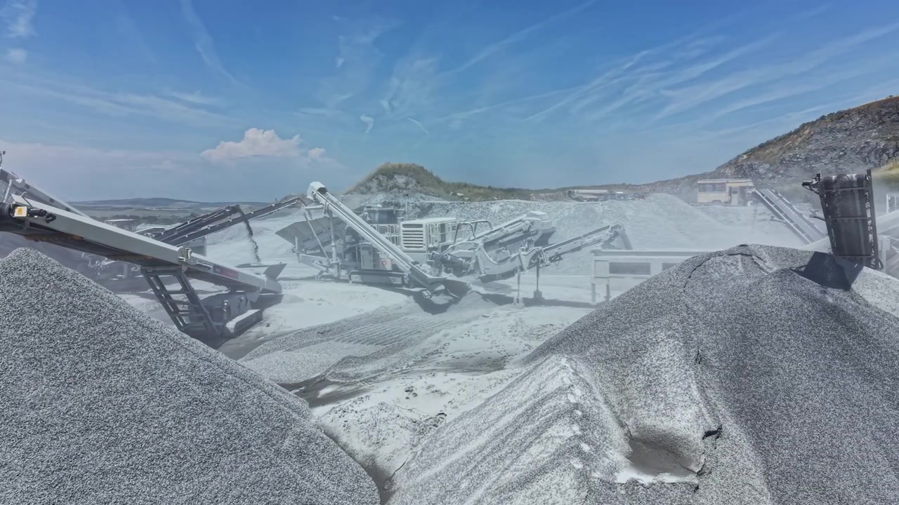 Granite quarry operations with machinery working in the background during daylight