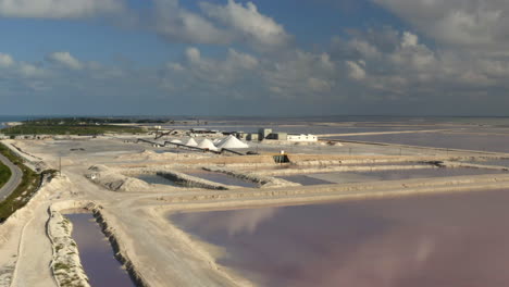 pink salt evaporation ponds and salt mounds in sea saltern in mexico