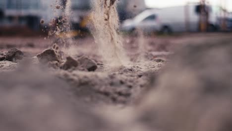 close up, scooping dirt with shovel at a construction site