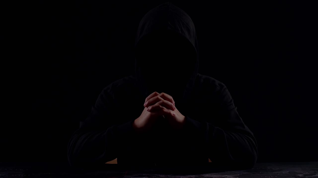 Mysterious Man With Hoodie In Silhouette Isolated On Black Background