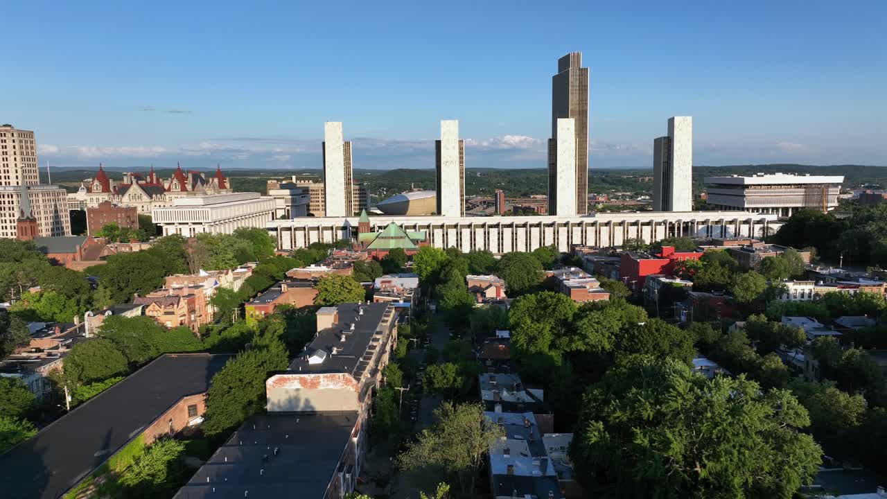 Peaceful scene in American town of Albany, New York. Sunset time in USA. Empire state plaza with office buildings and famous New York State Capitol building on the left. Aerial wide shot