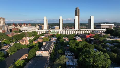 peaceful scene in american town of albany, new york. sunset time in usa. empire state plaza with office buildings and famous new york state capitol building on the left. aerial wide shot