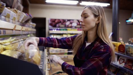 female staff working at bakery section of supermarket