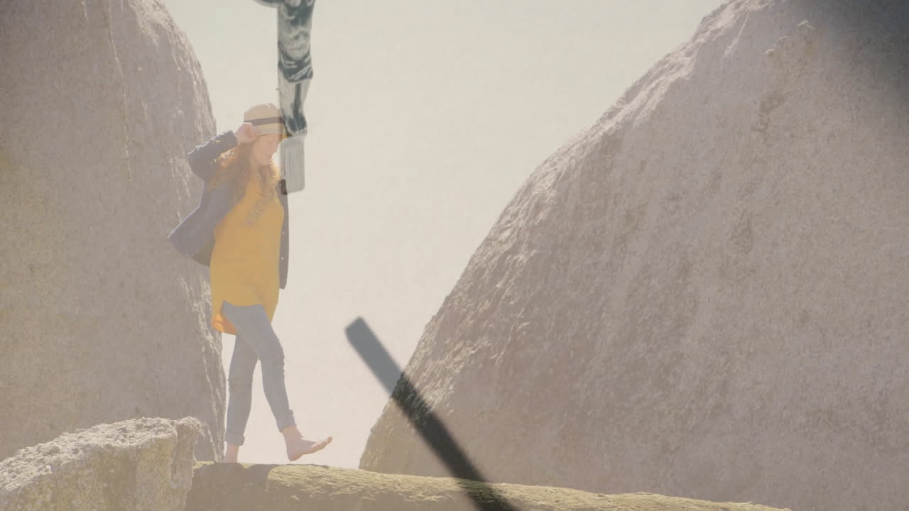 woman balancing barefoot on fallen log between granite boulders, showing technology data overlays