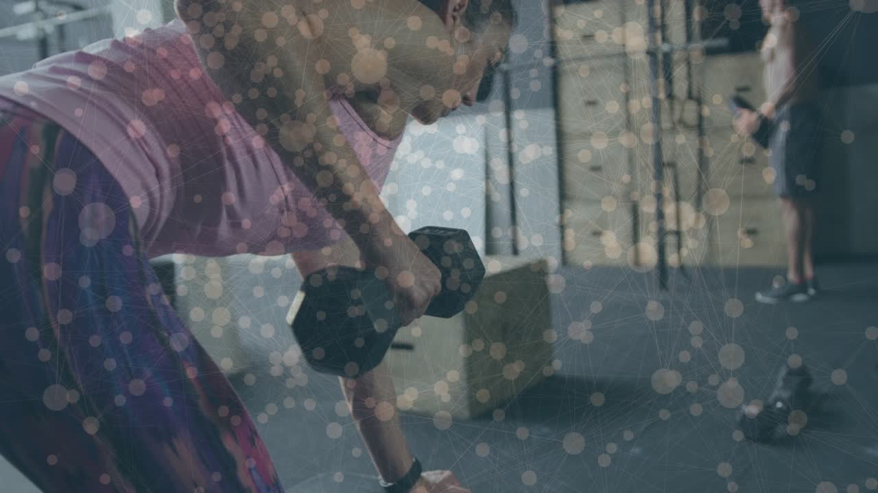 Woman starting bent forward, pulling hex dumbbell toward torso for fitness, bokeh overlay appearing