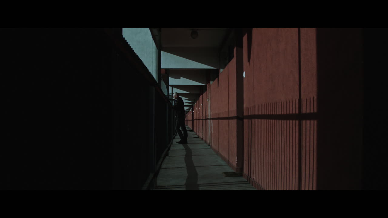 A bald gang member on guard