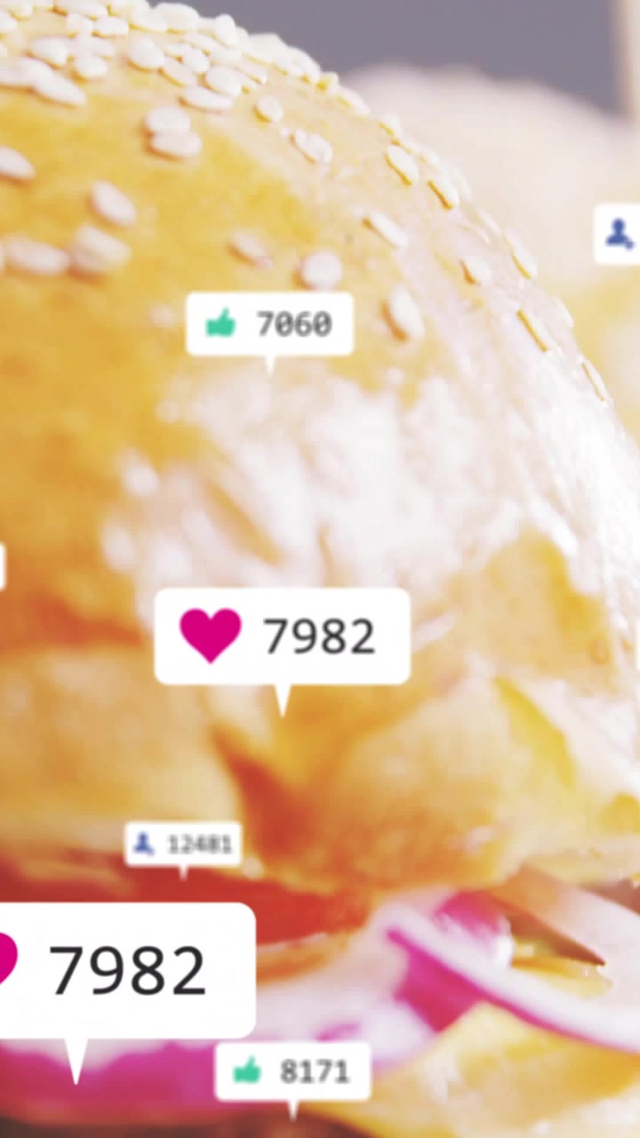 Vertical video: Burger revealing while heart popup overlaying and updating likes for food marketing