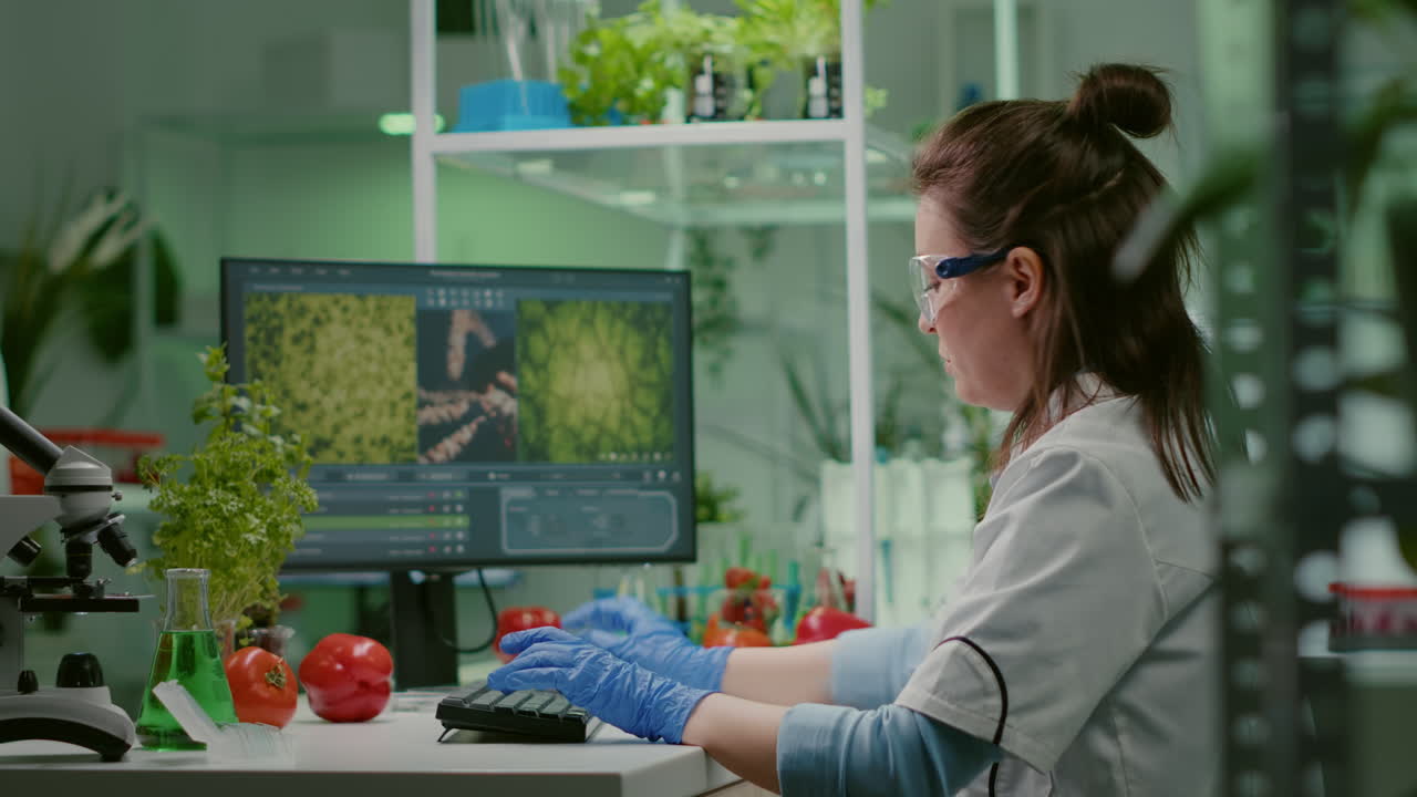 Scientist woman researcher typing biochemistry expertise on computer