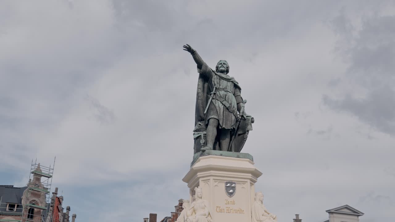 The statue, created by Pierre De Vigne-Quyo, is located in the middle of the Vrijdagmarkt (Friday Market Square) in Ghent, Belgium, and features the figure pointing with a raised arm