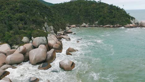 Rocky-rainforest-coastline-aerial-view-on-cloudy-day