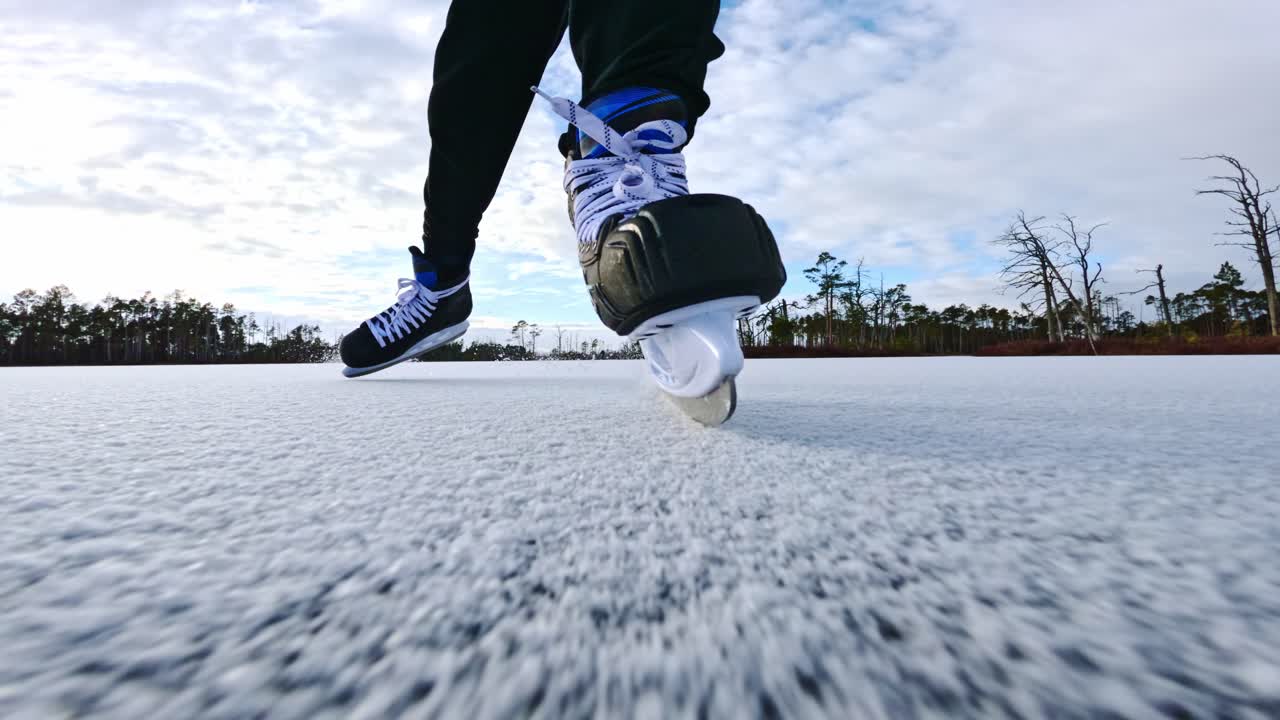 Low Angle Front of Man Skating, Motion Blur on Frozen Lake in Northern Europe