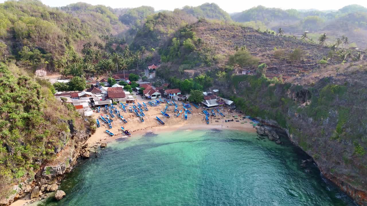 Beautiful fishermen village surrounded with mountains, aerial drone view