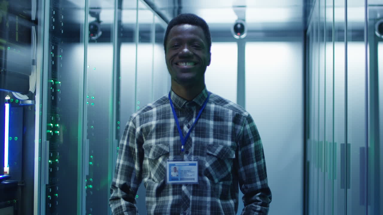 Smiling IT Professional in a Data Center