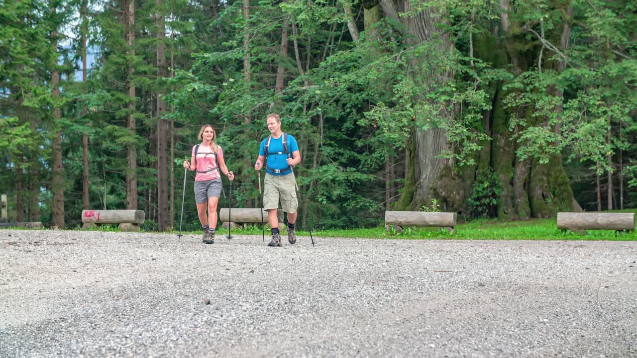 Hiker couple at a rest area look back at the forest they have crossed