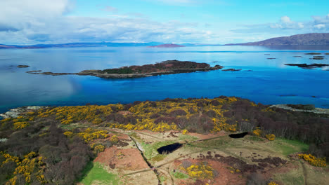 scenic coastal views off the coast of skye island scotland, calm atlantic ocean waters reflect cloudy sky