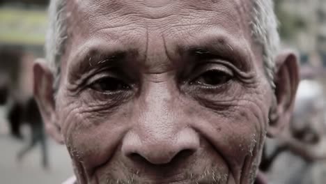 an elderly man smiles widely, showcasing the beauty of his weathered face. the vibrant energy of a market surrounds him, highlighting moments of connection and joy in daily life.