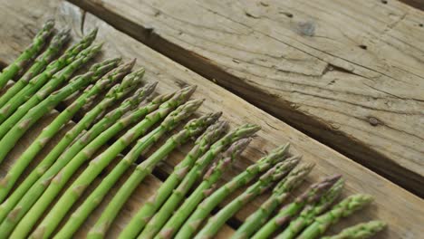 Video-of-fresh-asparagus-stalks-on-wooden-background