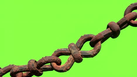 a close-up view of an old and rusty chain-link fence against a green screen background