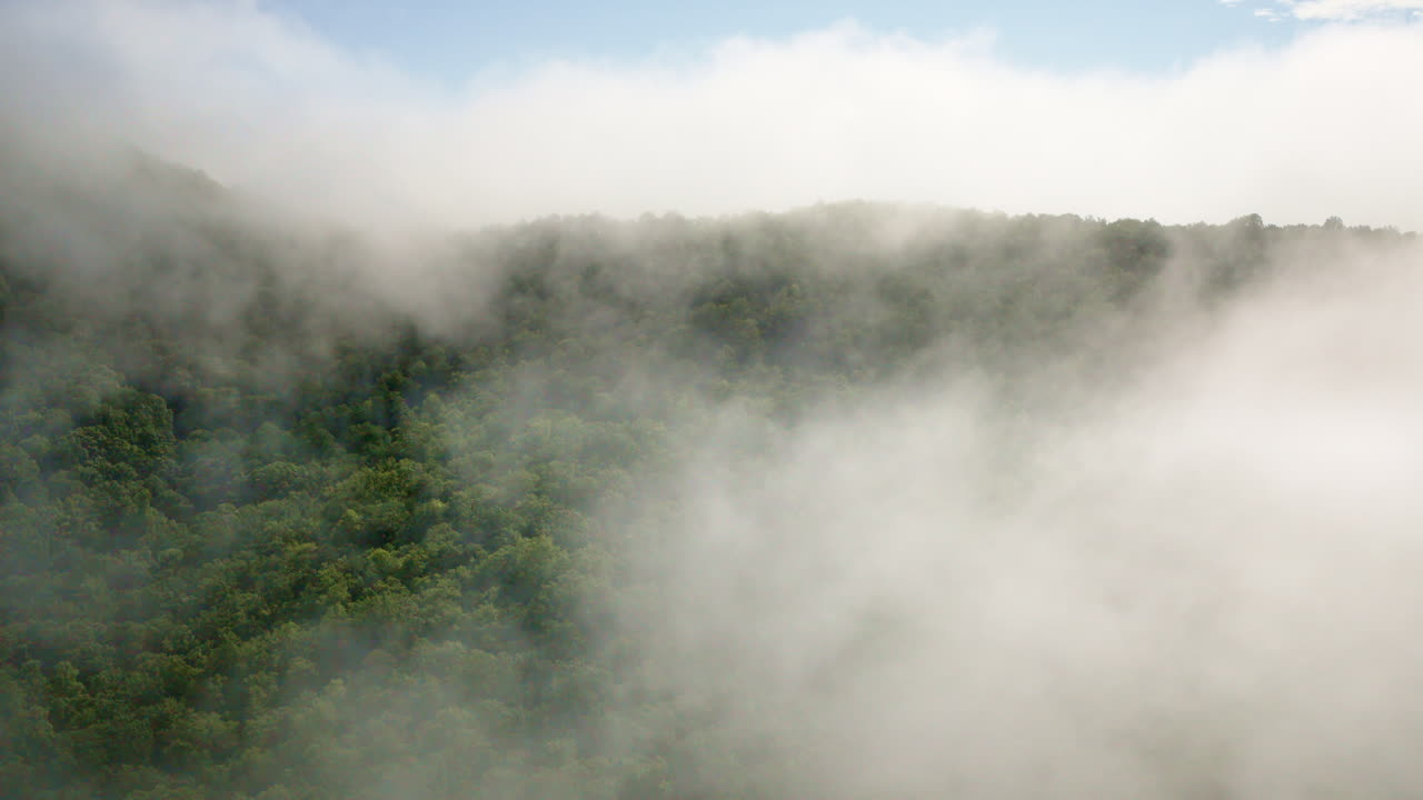 Aerial cinematic shot drifting slowly into mist over the Smoky Mountains