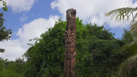 new caledonian totem in a forest under the bright light of day