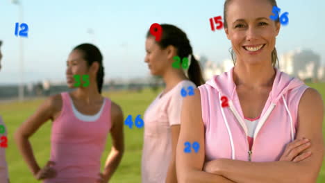 Numbers-animation-over-women-in-athletic-wear-standing-on-field