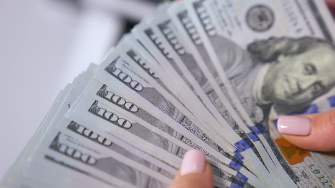 Female hands counting us dollars. Woman hand count the united states currency. A bunch of american Banknotes.